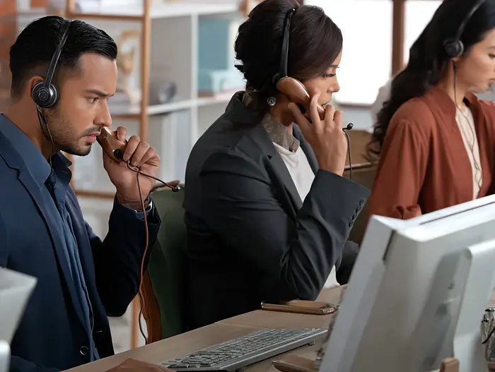 People at an office talking to customers over the phone